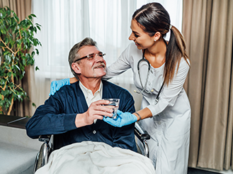Compassionate nursing care with Caringhand healthcare professional assisting senior man in wheelchair